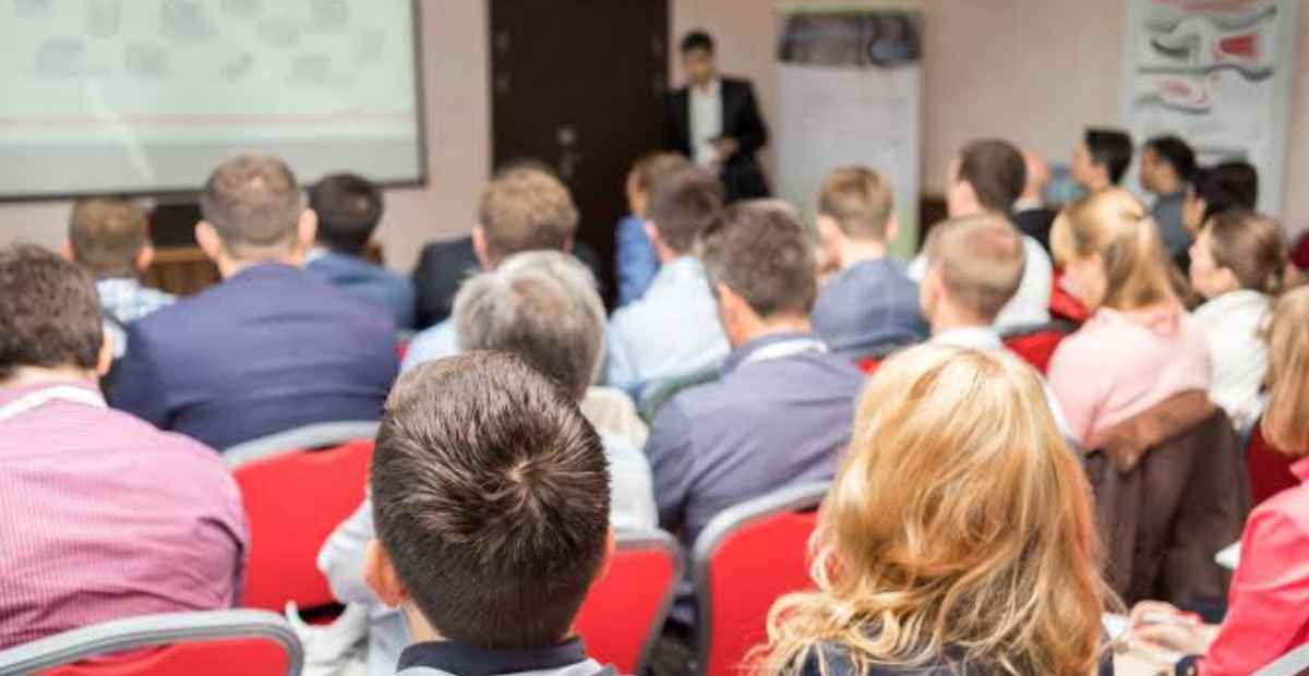 Invest in training your employees | A conference room with employees