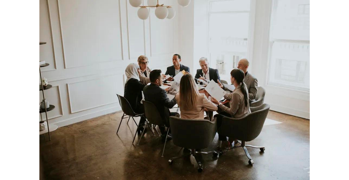 Keep meetings small | team members having a round table meeting